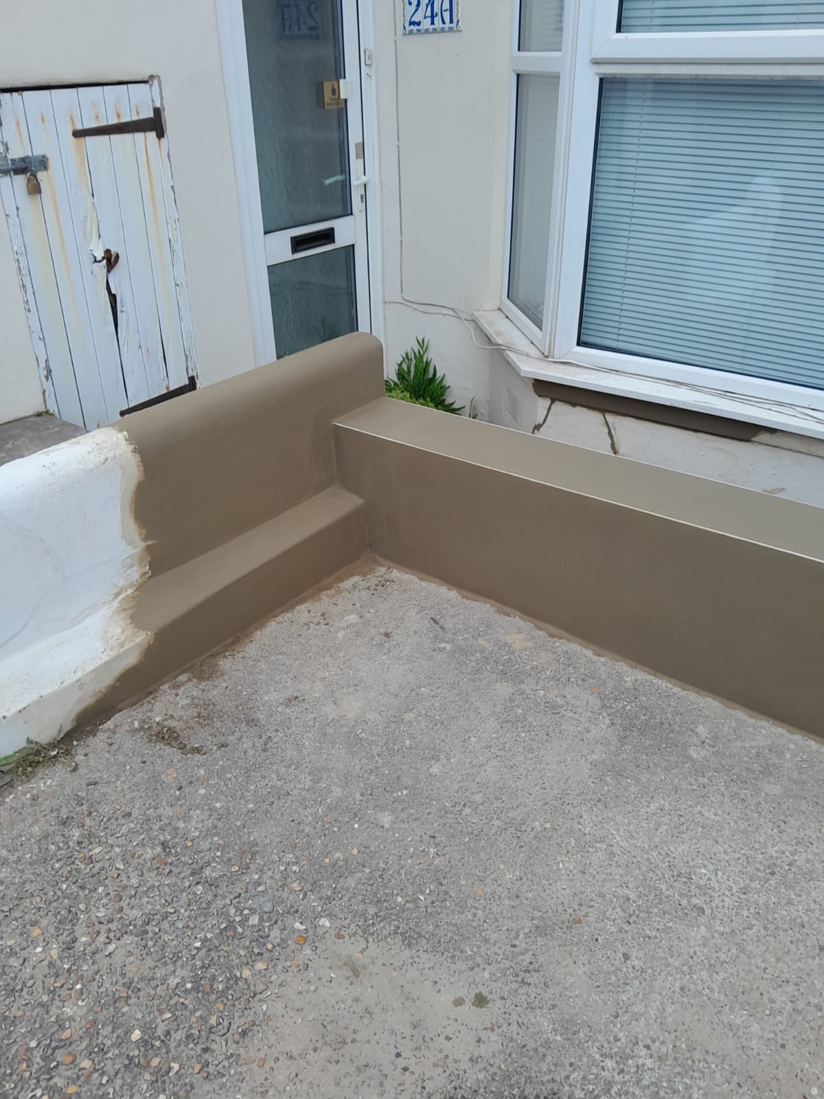 Completed rendered wall corner showing rebuilt section ready for painting — Old Shoreham Road, Brighton